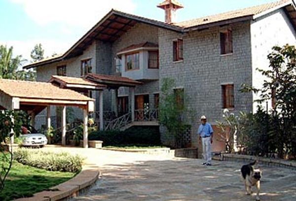 Magnificent granite home with coconut palms, jasmine, mango, bananas.