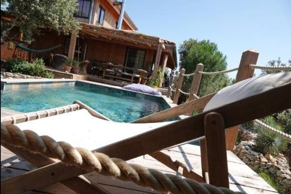 Lodge avec piscine au milieu des arbres, vue sur la garrigue, pour les amoureux de vacances natures.