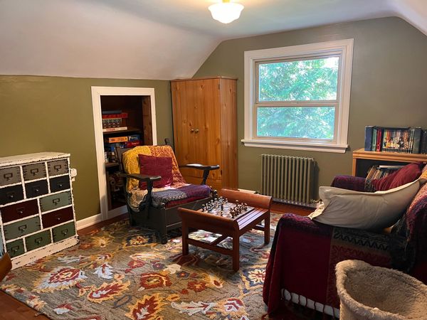 Homestay with private room, bathroom, and sitting area.