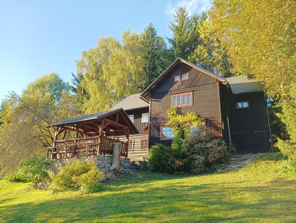 Romantic wooden cottage near forests and mountains