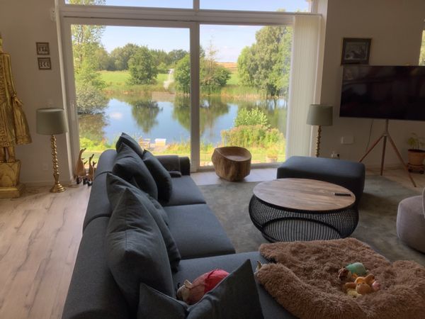 Elegant lakeside home with panoramic views, peaceful setting, modern comfort and close to Odense.