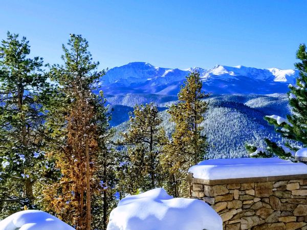 Castle above the clouds with Pikes Peak Views