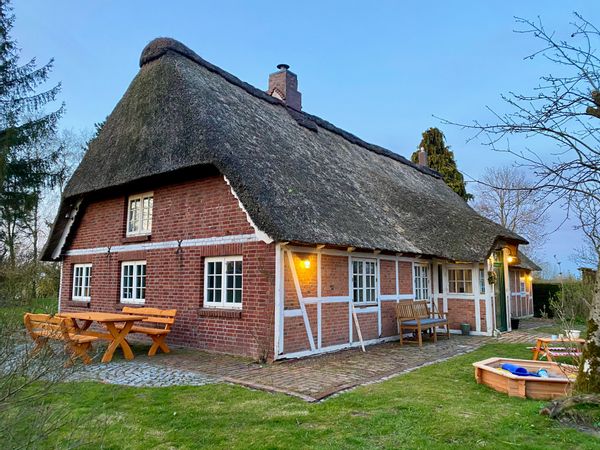 Old Farmhouse with thatched roof in a natural surrounding