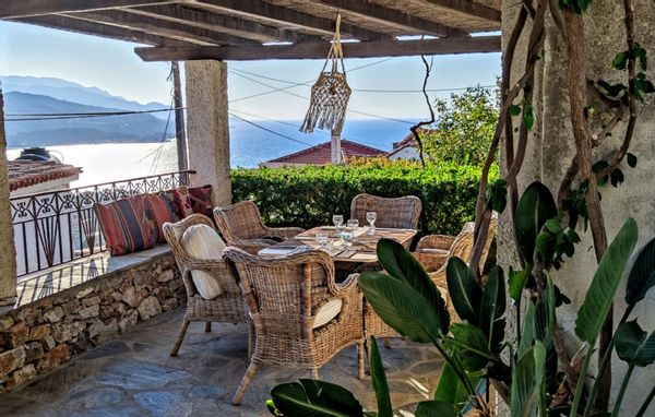 Stone houses with garden, sunset in the Aegean Sea