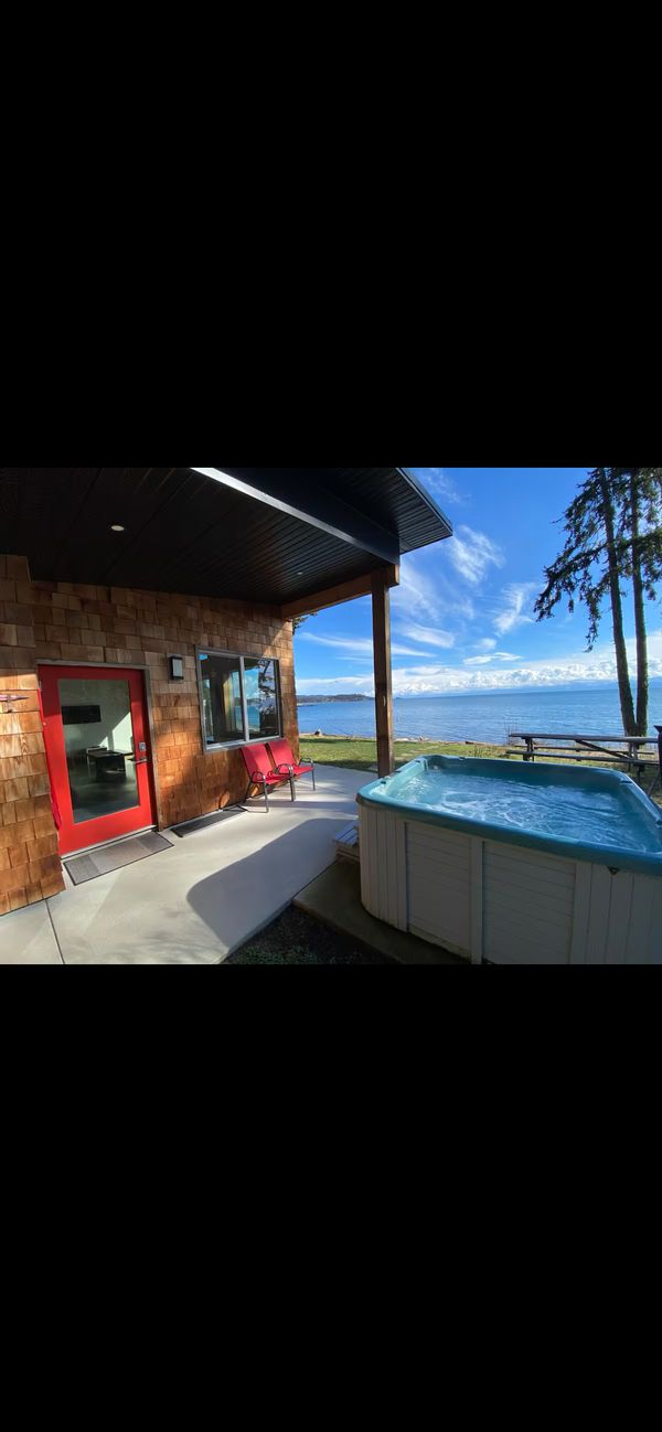 Oceanfront cabin with King bed in 1 bedroom and bunk bed in other bedroom. Pebbly beach out front.