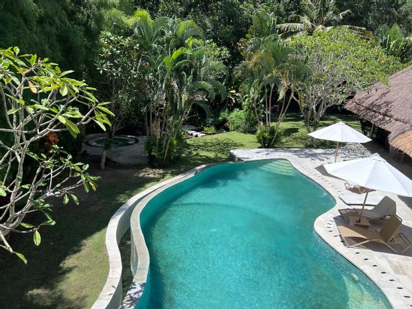 The family home is surrounded by lush green vegetation, spacious, and cozy. A true gem!