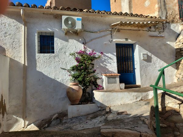 Traditional whitewashed ramshackle Spanish cottage with terrace in an authentic Spanish village.