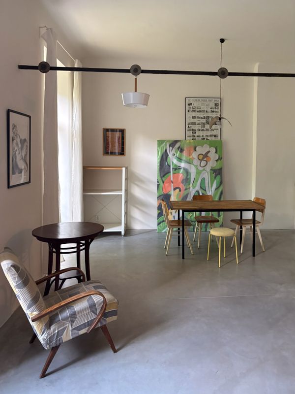 A spacious, cozy studio with artistic details, a large TV, and a private entrance to the backyard.