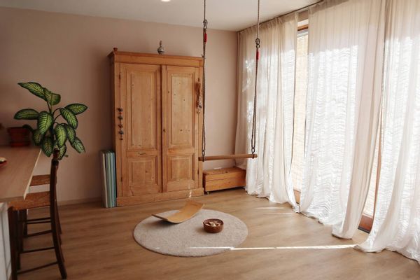 Sunny, kid-friendly home with a trapeze and a garden with a trampoline.