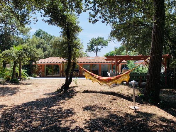 Maison années 70, baies vitrées donnant sur un jardin boisé, à 10 mn à pied du centre et de l'océan.