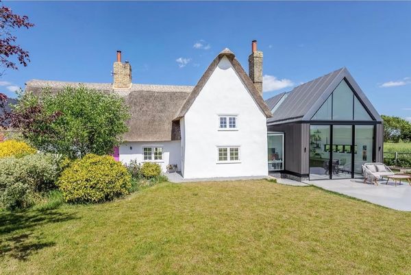A grade II listed 400 year old thatch cottage with a modern glass link extension. Family friendly