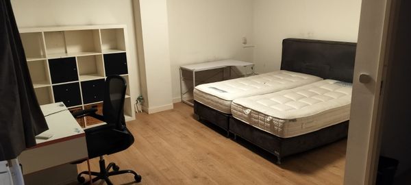 Spacious AC room on 2nd floor with king bed. Ideal for couple/2 guests. Shared kitchen & bathroom.